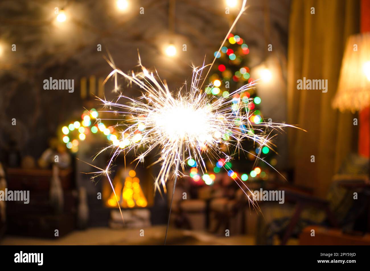 Bengal fire on Christmas tree background Stock Photo