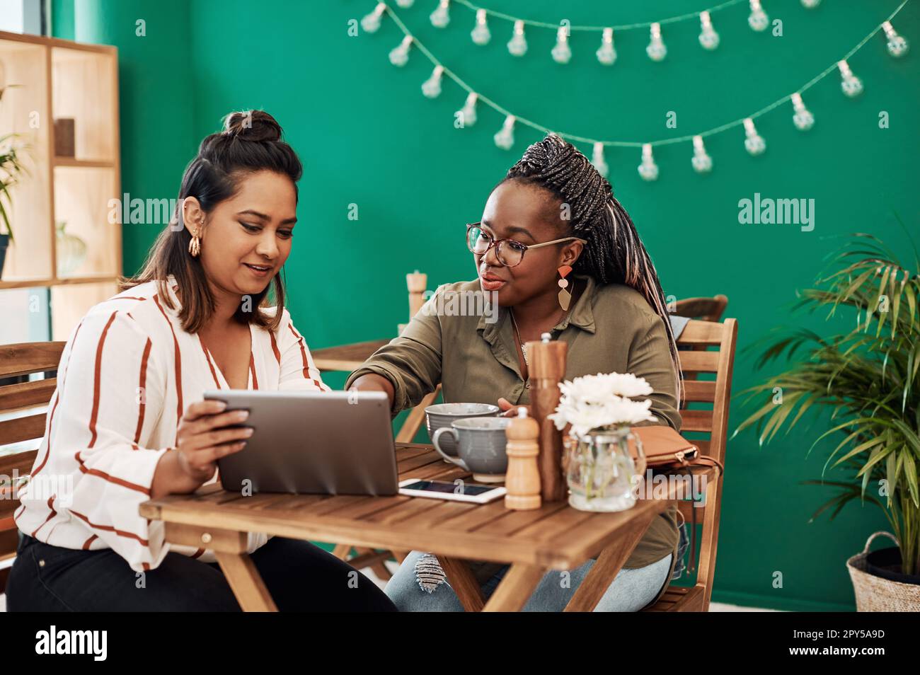 Smart tech supports that social butterfly life. two young women using a ...