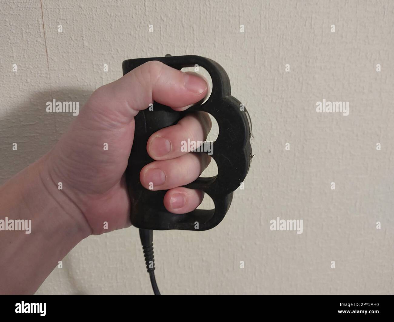 Taser brass knuckles for selfdefense and the defense Stock Photo Alamy