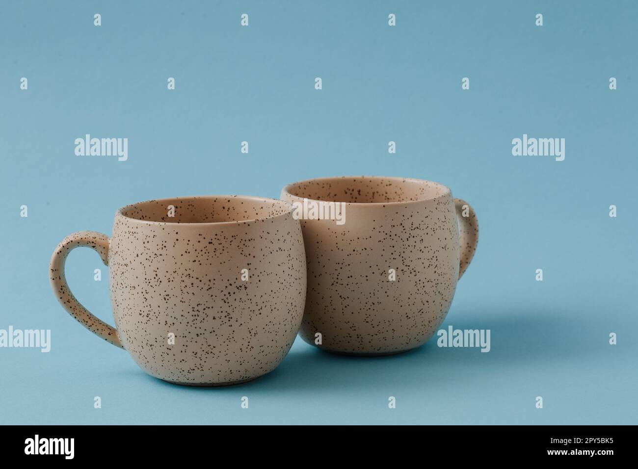 Two porcelain empty cups on a blue background, copy space Stock Photo