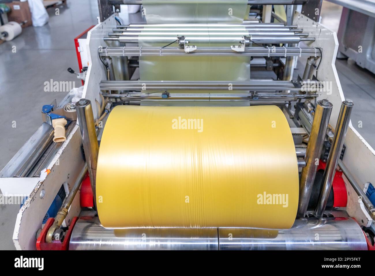 plastic roll on a machine for the production of polyethylene bags Stock Photo