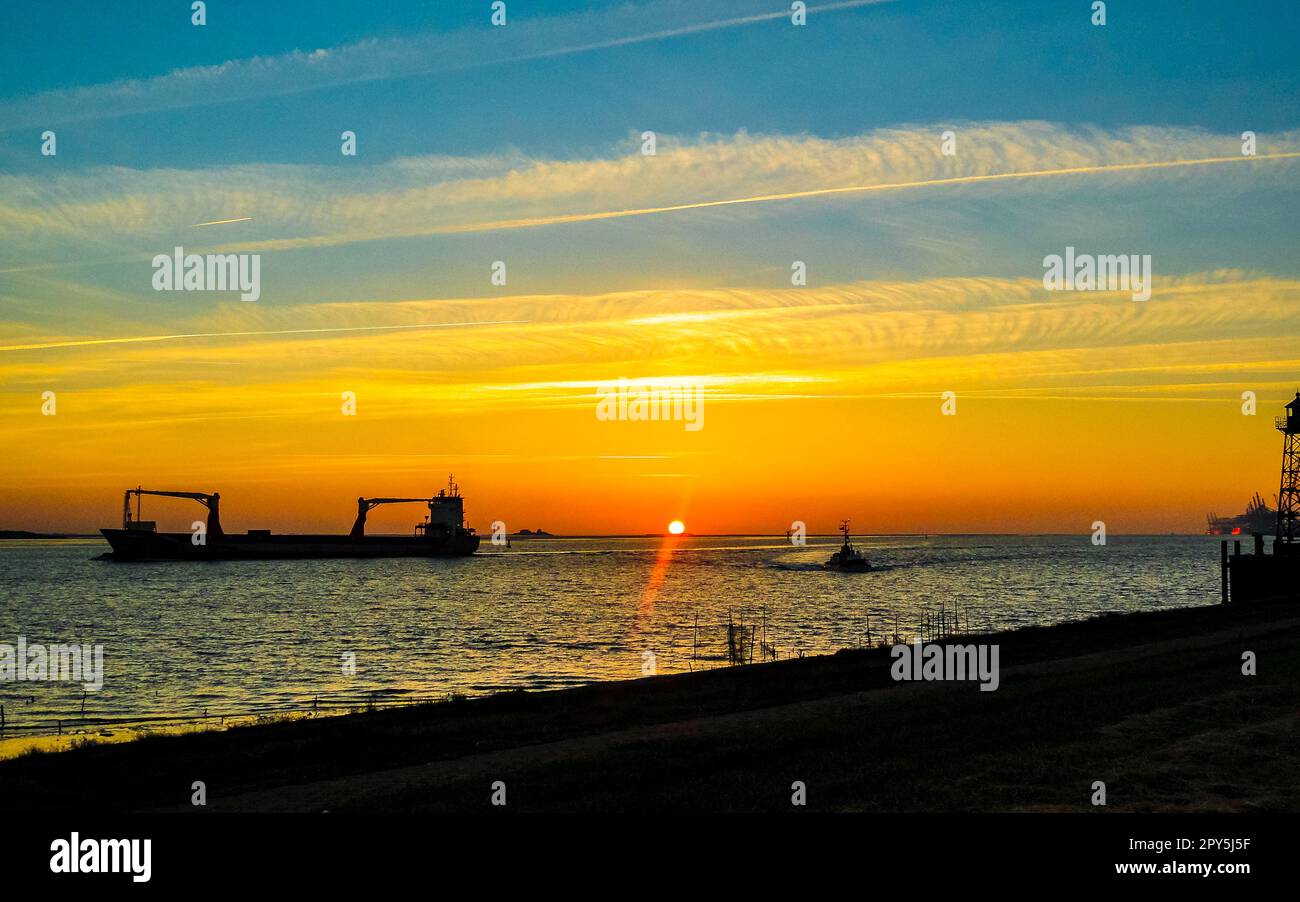 Beautiful colorful golden sunset North Sea coast Bremerhaven to Nordenham. Stock Photo