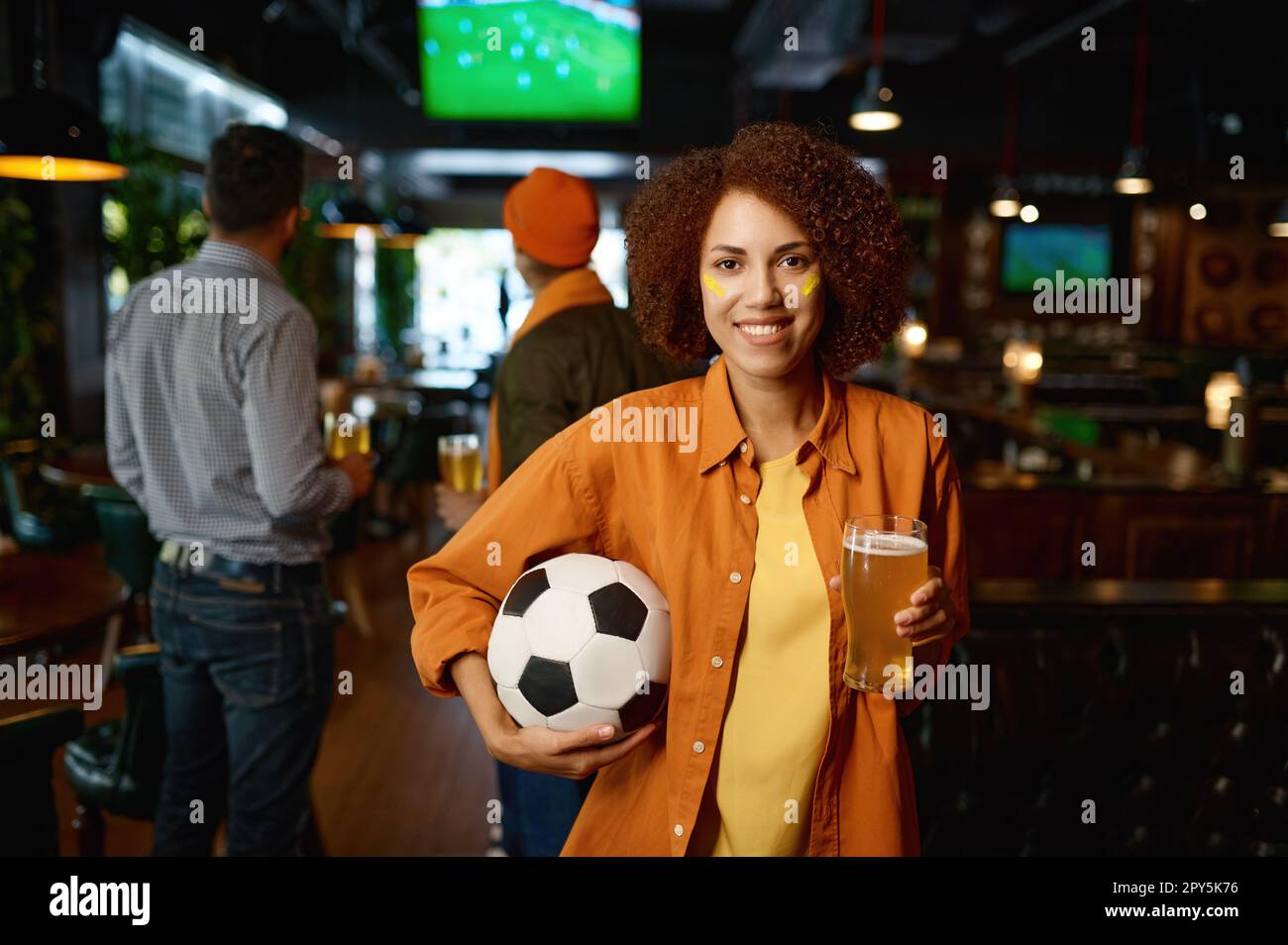 Portrait of beautiful woman football fan with beer glass Stock Photo