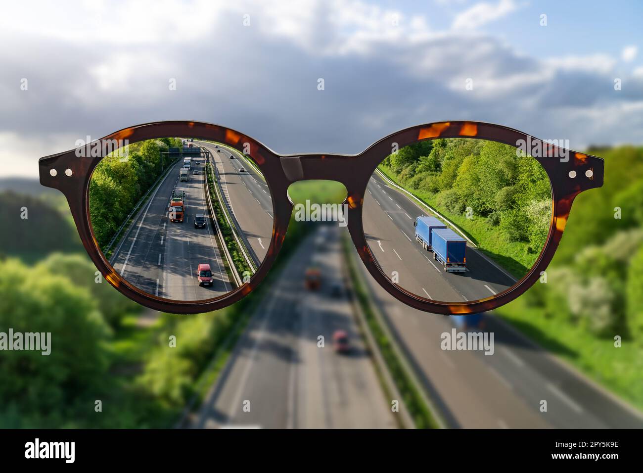 Eye glasses against ametropia sharp panorama view over a Highway without of focus photo parts. Stock Photo