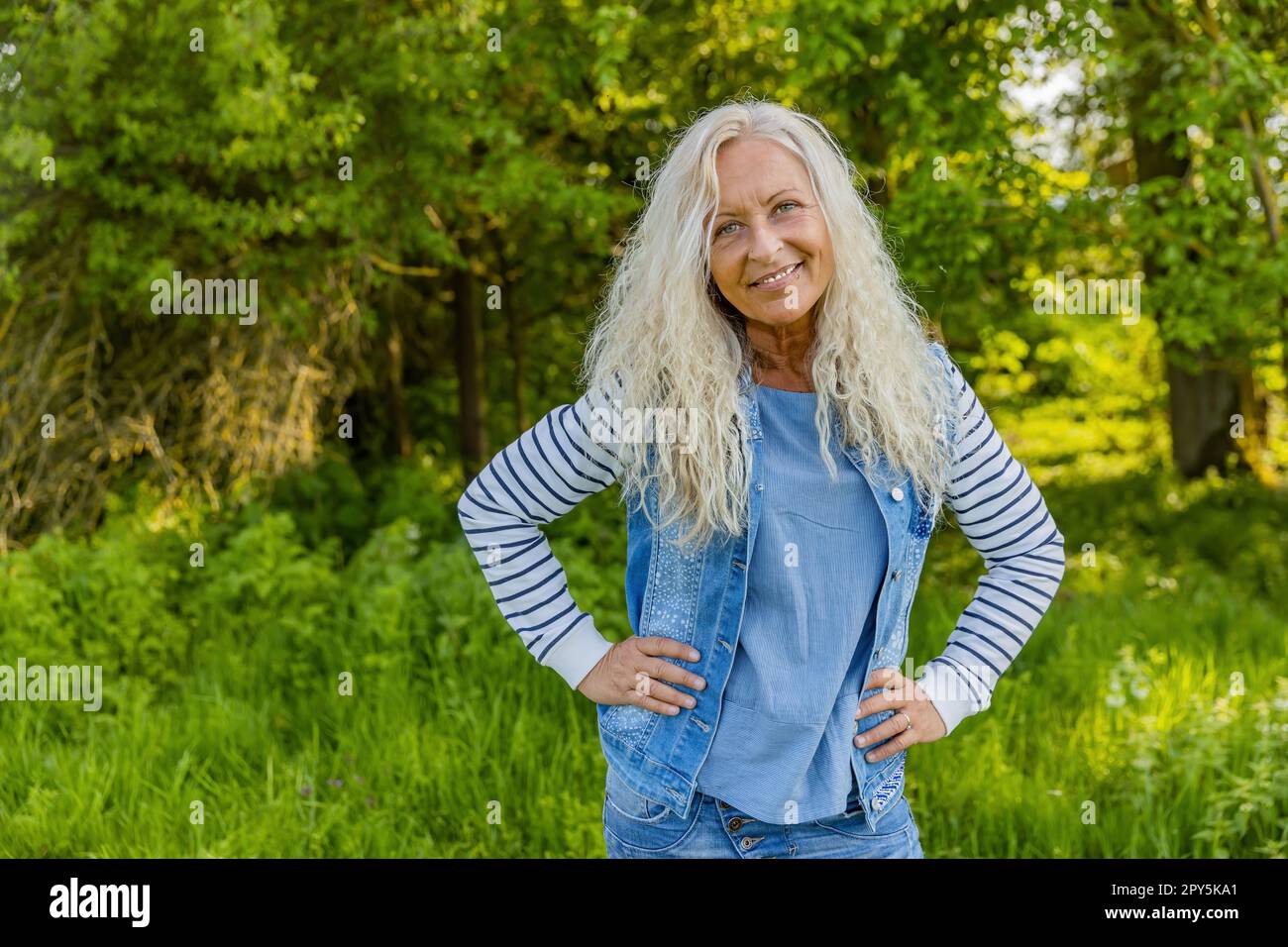 Woman hold her arms to her hips Stock Photo