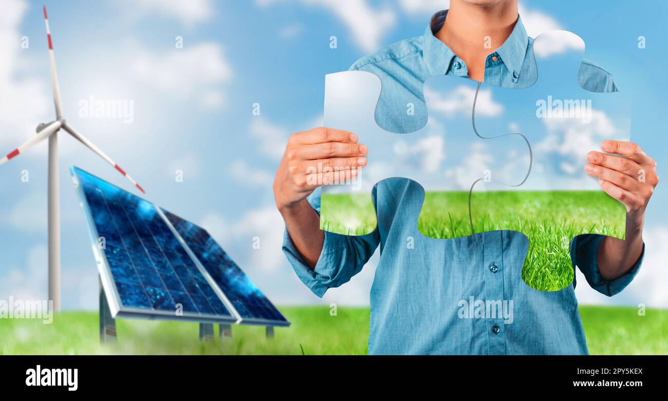 Renewable energy system with solar panel, rebuild with puzzles a landscape Stock Photo