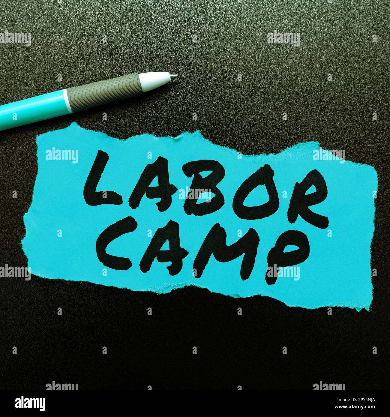 Conceptual caption Labor Camp. Word for a penal colony where forced labor is performed Stock Photo