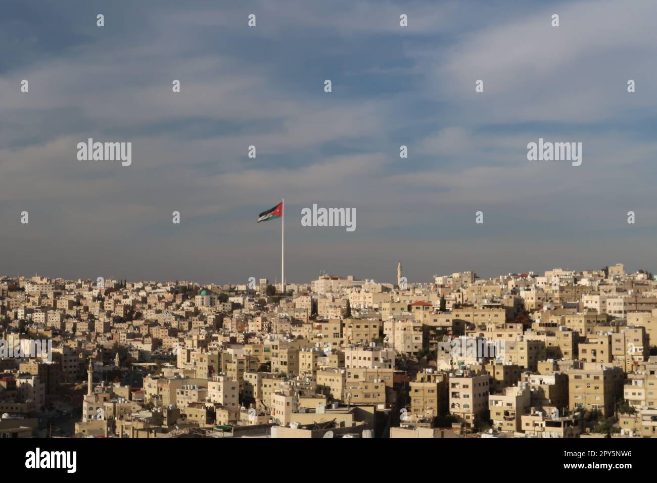 Jordanian Flag over the skyline of Amman, Jordan Stock Photo