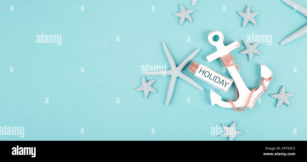 Summer vacation background, anchor, sea stars and a glass bootle with the word holiday, travel and tourism concept Stock Photo