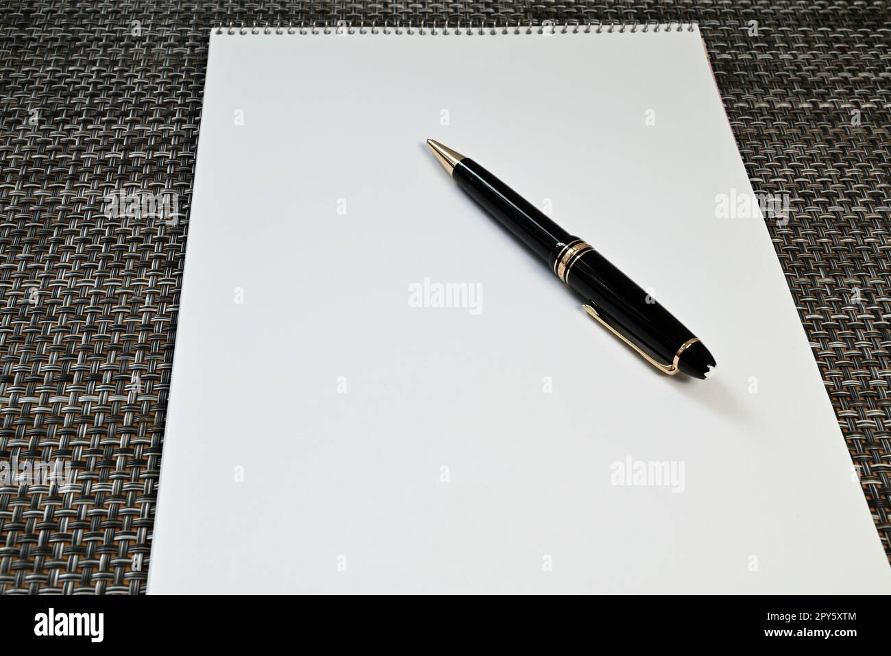 Ballpoint pen on white sheet of paper Stock Photo