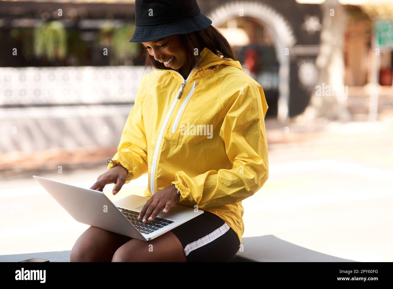 Dare to stand out and be yourself to the fullest. an attractive young woman using a laptop while relaxing outdoors in the city. Stock Photo