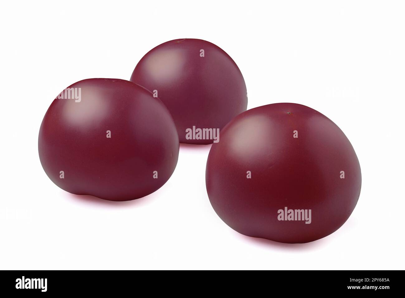 Three purple tomatoes isolated on white Stock Photo