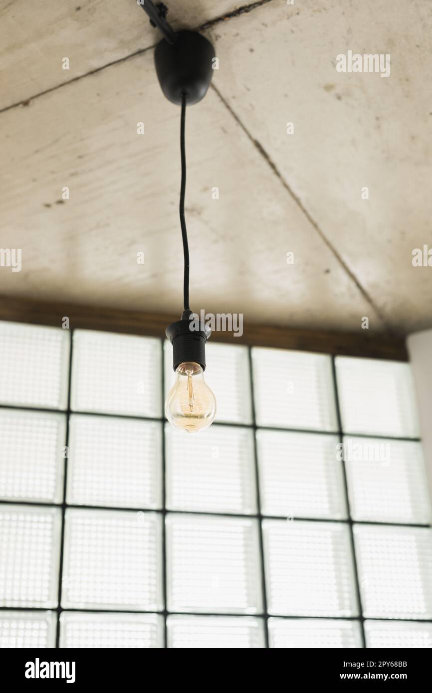 vintage light bulb hanging from ceiling in living room Stock Photo Alamy