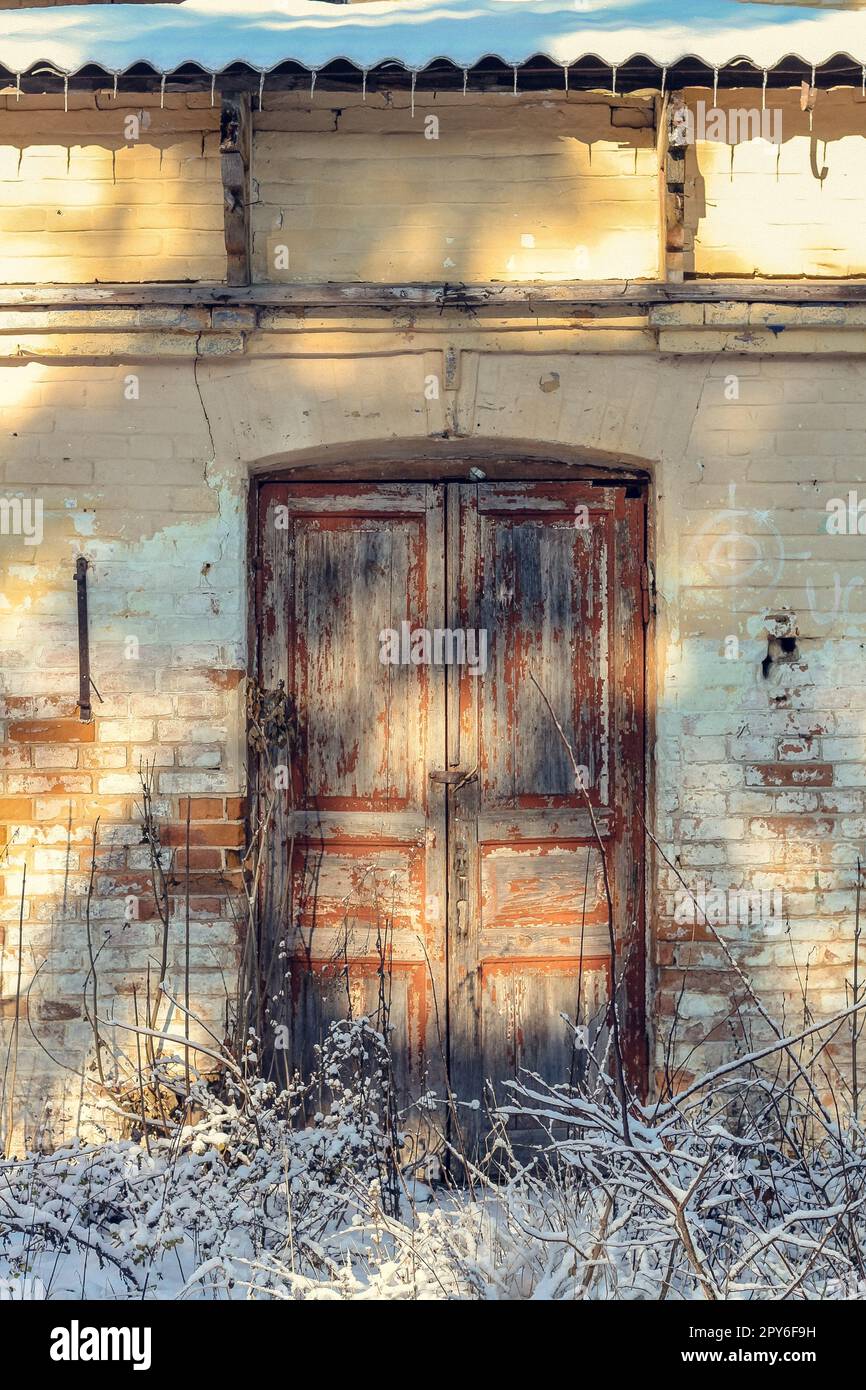 Close up old paint peeling door of abandoned building exterior concept photo Stock Photo