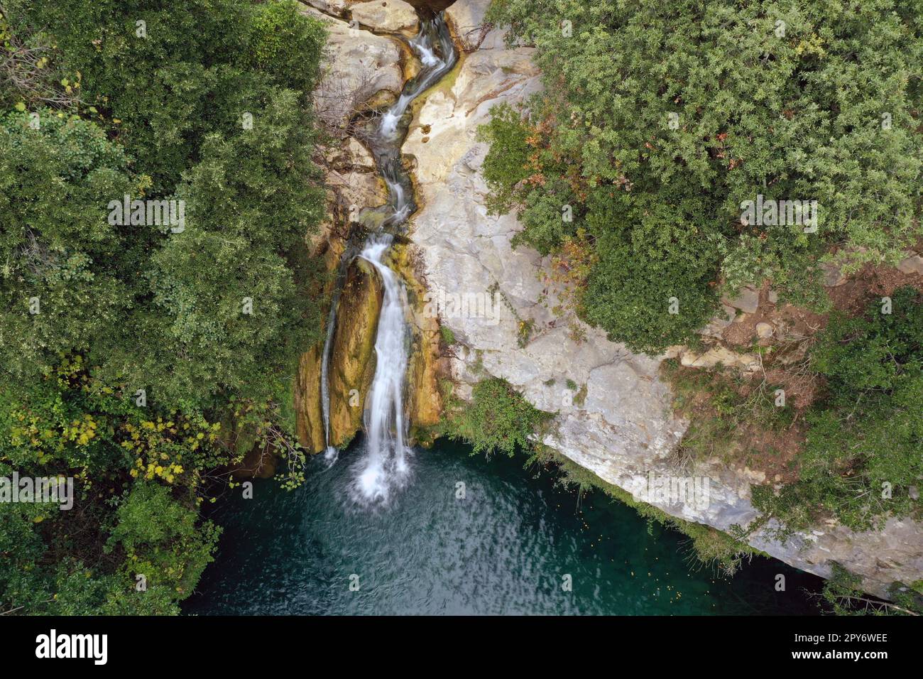 Waterfall in the middle of the forest Stock Photo - Alamy