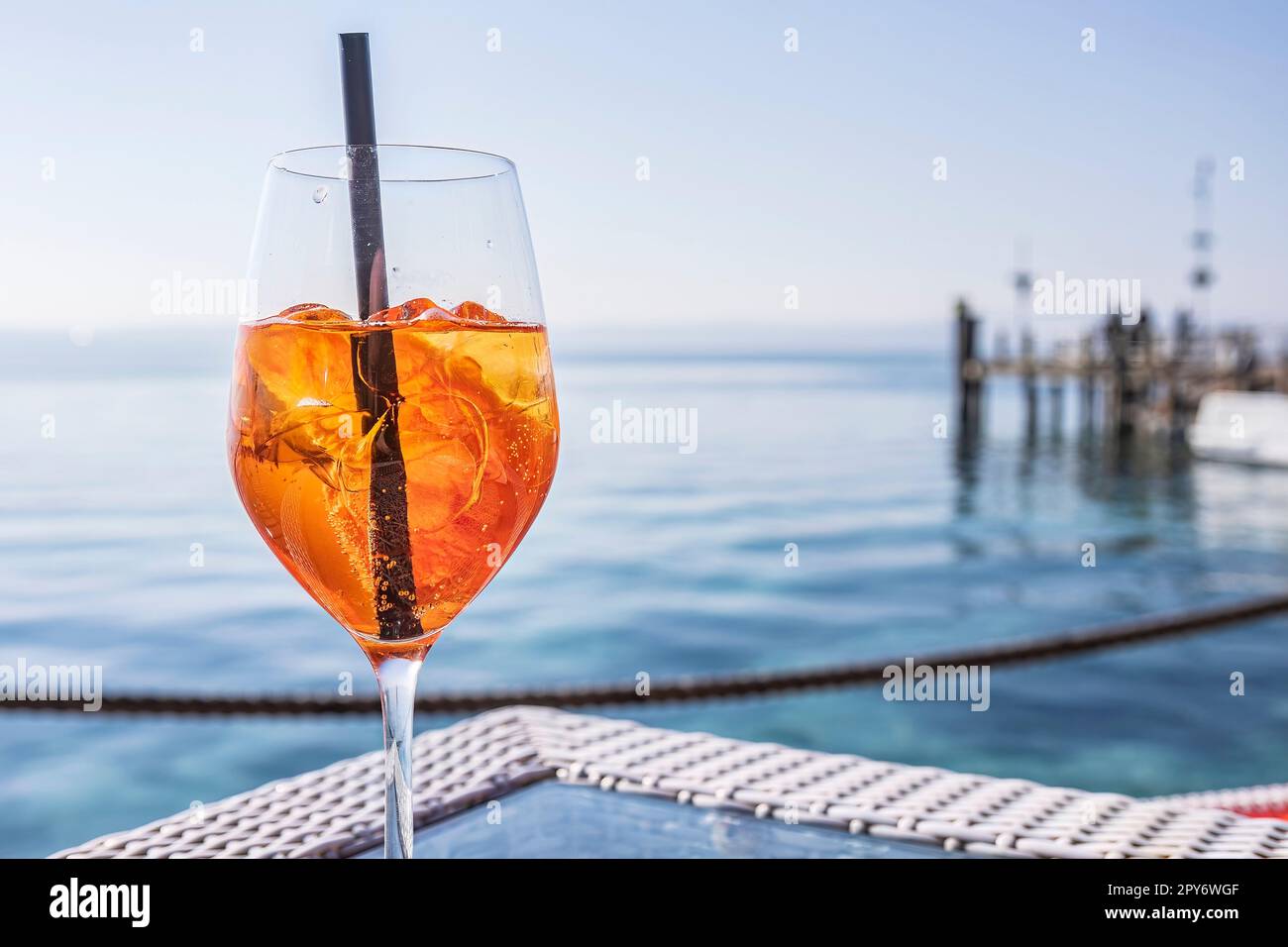 Cheers to good times: Elegant glassware on a seafront bar table Stock Photo
