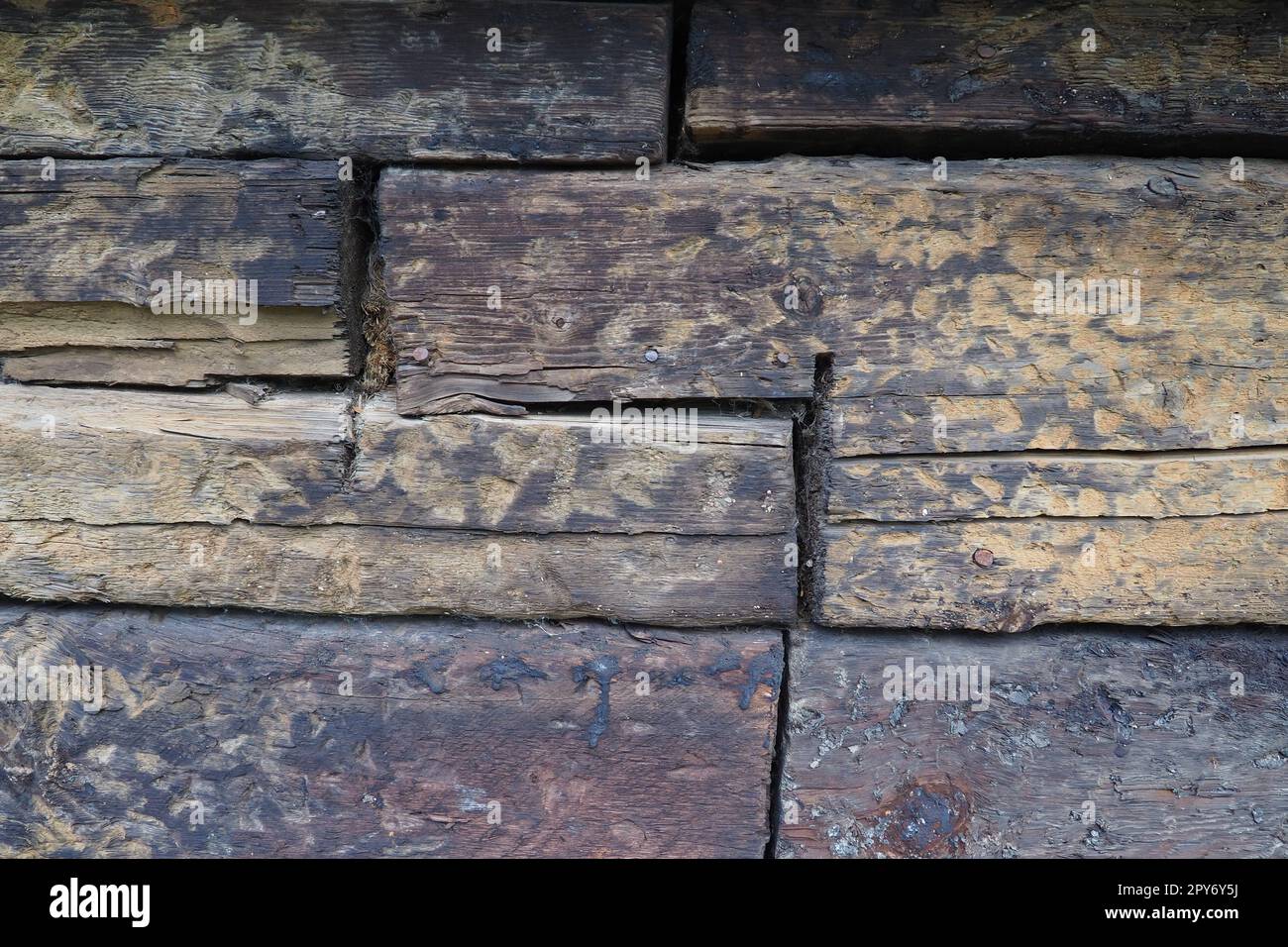 Background horizontal logs. Wooden background from shabby boards and logs. General purpose lumber. Special type of forest products. Old sleepers Stock Photo