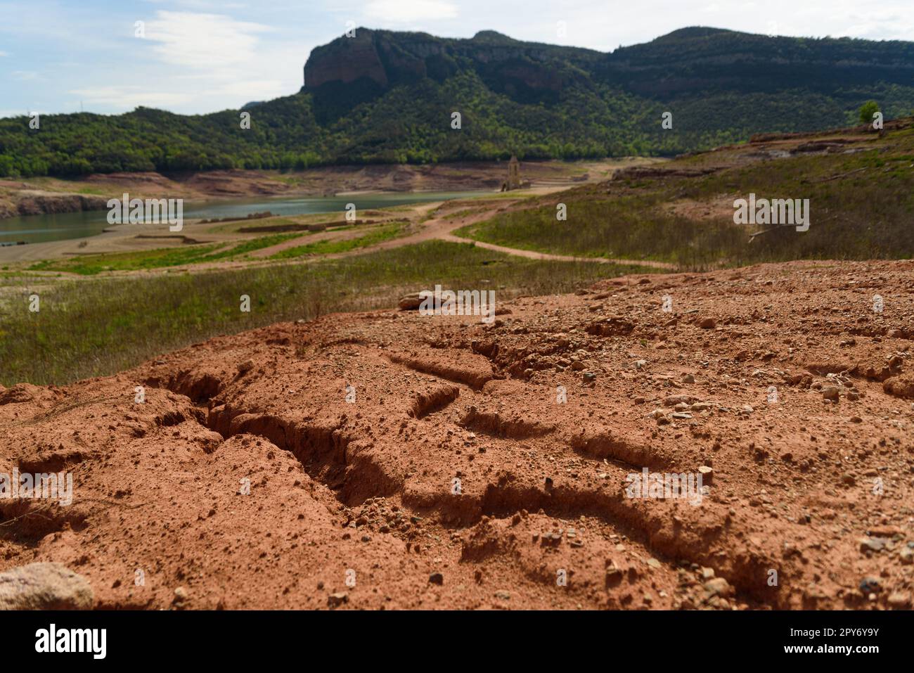 Scorched earth and earth clods are seen on dry land caused by drought and lack of rain due to climate change. Concept of water shortage and climate cr Stock Photo