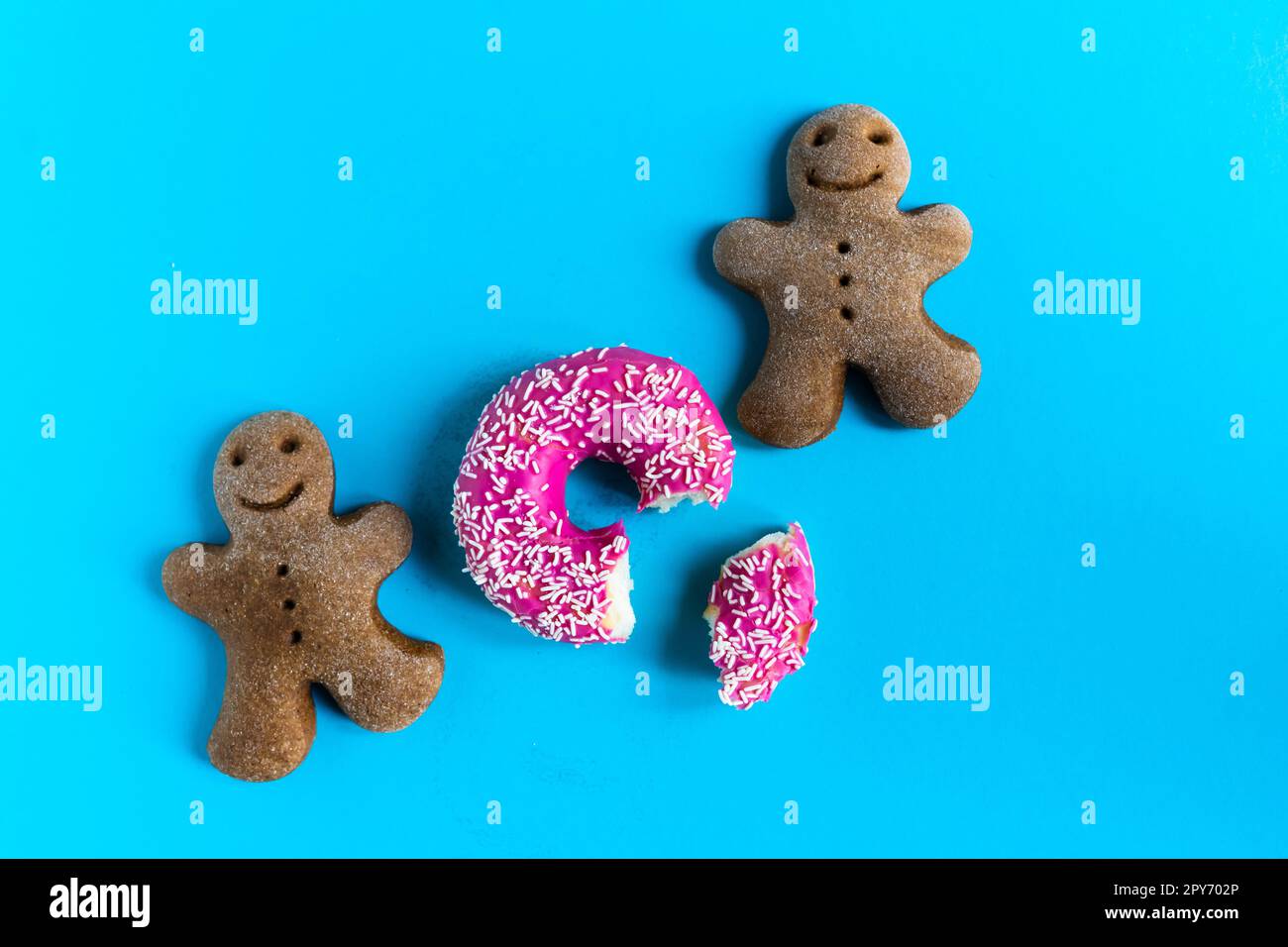 Donut with hazelnuts on blue background, close up Stock Photo