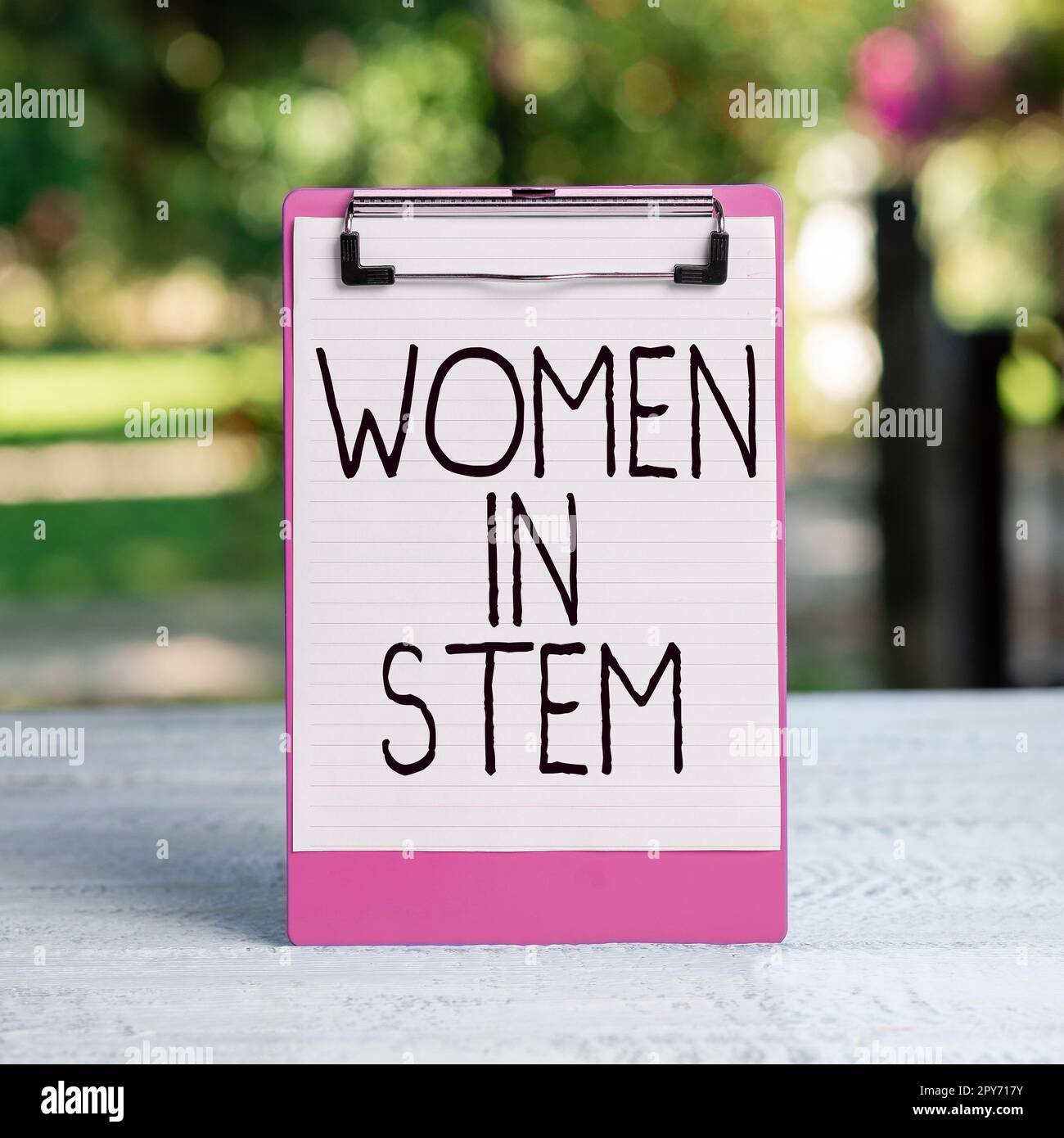 Hand writing sign Women In Stem. Concept meaning Science Technology Engineering Mathematics