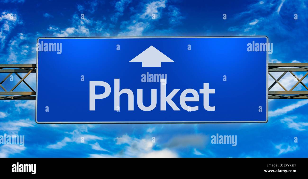 Road sign indicating direction to the city of  Phuket Stock Photo