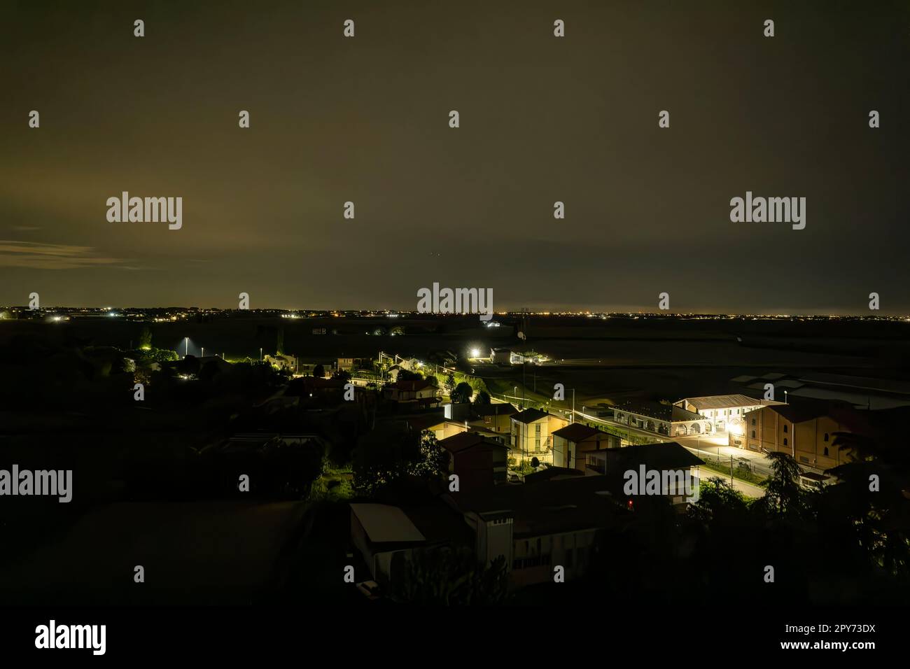 Enchanting aerial night view of a small Italian village nestled in the ...