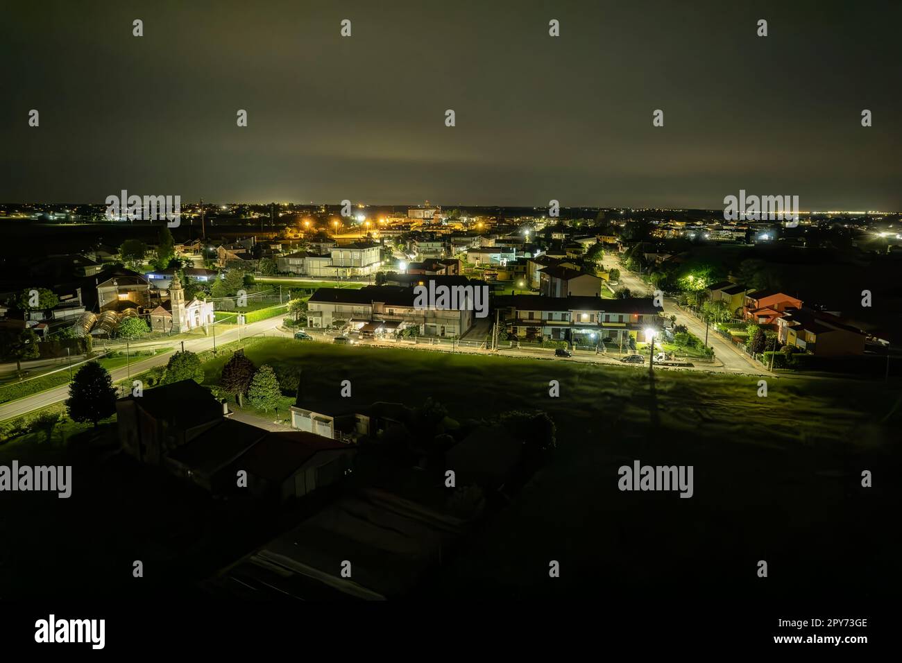 Enchanting aerial night view of a small Italian village nestled in the ...