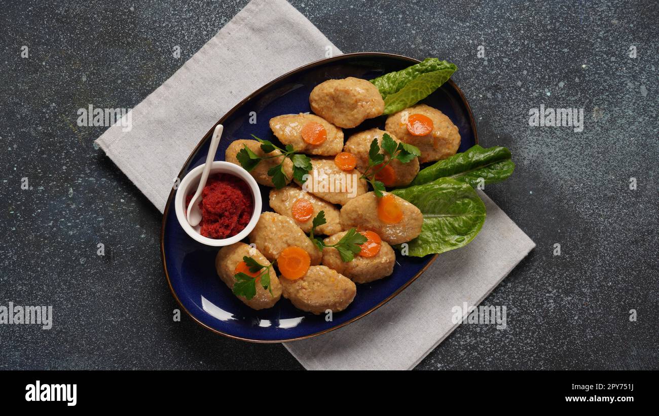 Gefilte fish with carrots, lettuce, horse radish. Passover traditional Jewish food - celebration concept Stock Photo