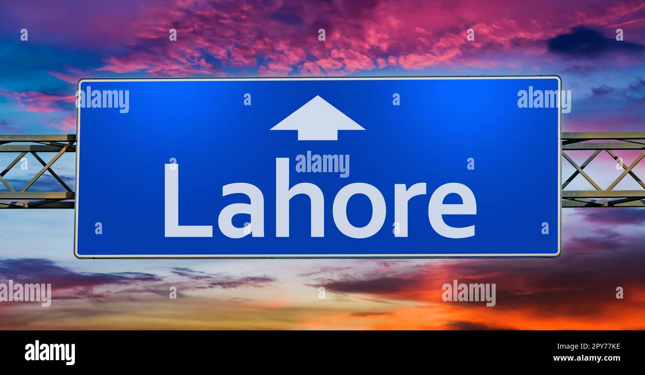 Road sign indicating direction to the city of Lahore Stock Photo