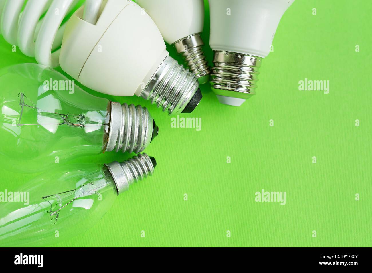 A set of different types of LED lamps isolated on a green background