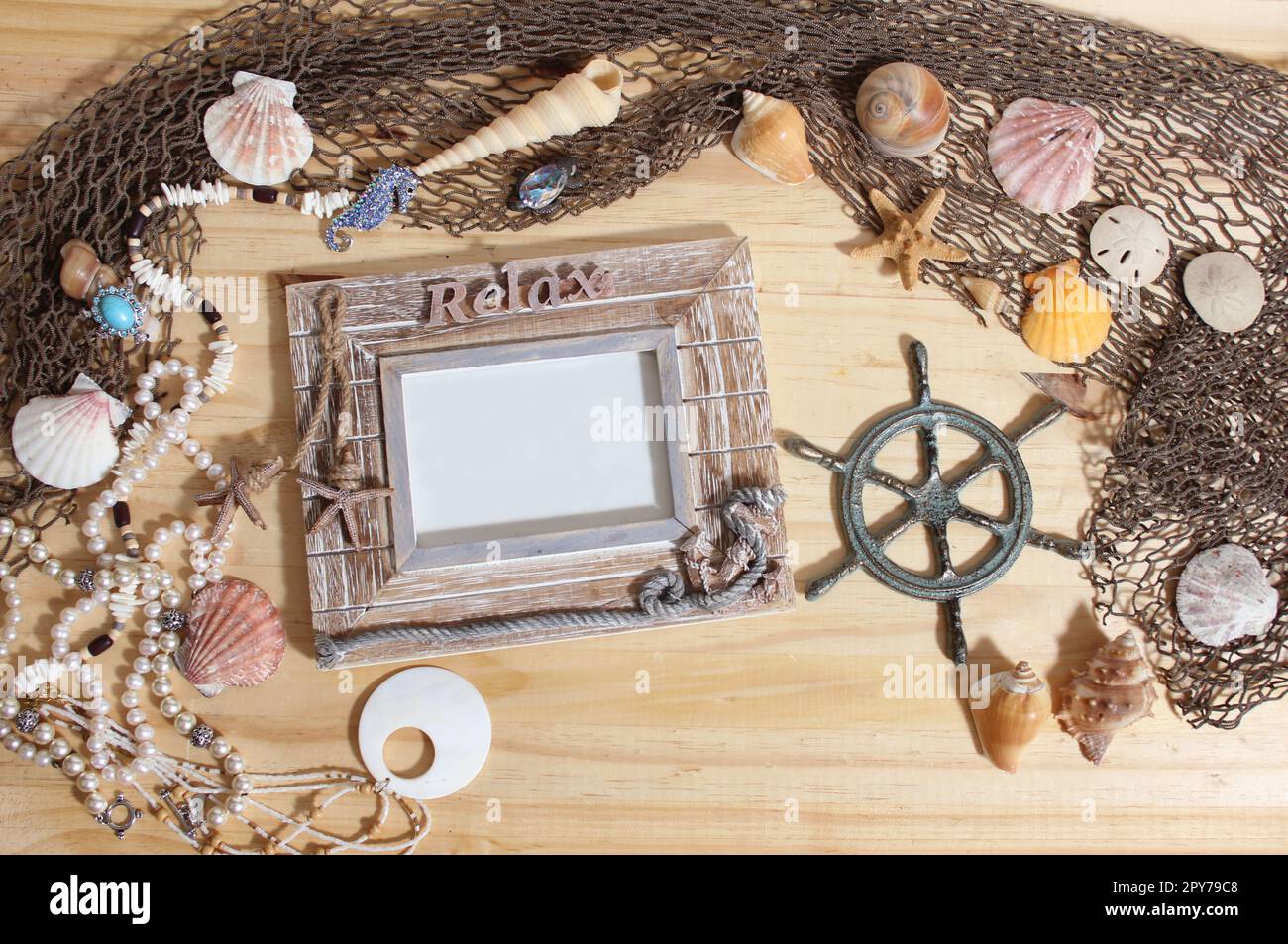 Empty Frame on Wooden Background With Sea Shells and Fishing Net. Nautical and Coastal Theme Stock Photo