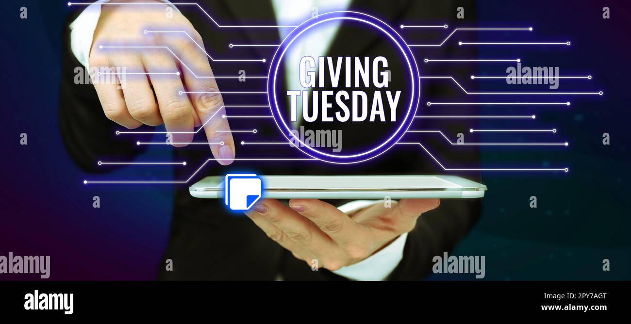 Hand writing sign Giving Tuesday. Internet Concept international day of charitable giving Hashtag activism Stock Photo