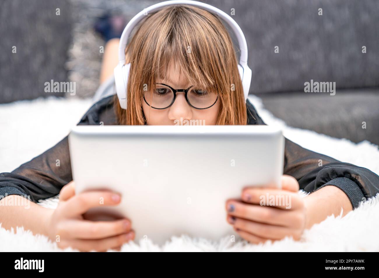 teenager with headphones and tablet on couch. children and modern technology, generation z Stock Photo