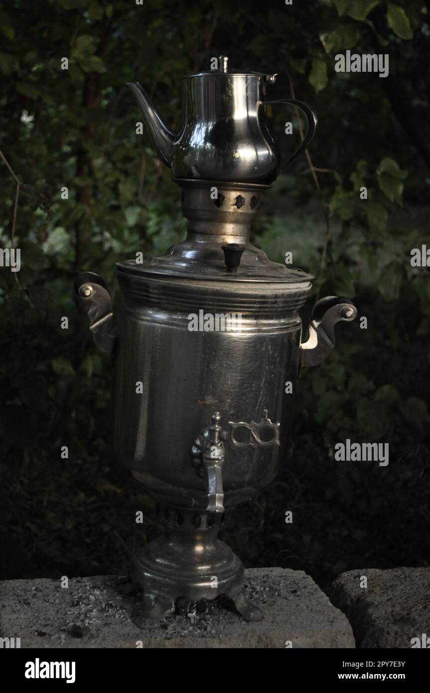 Vintage samovar in the garden at night, Russia. Stock Photo