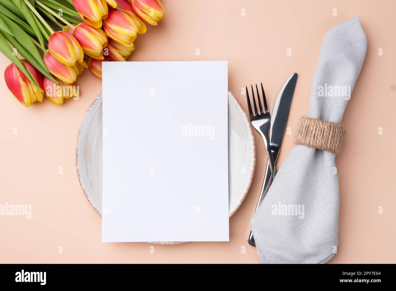 Menu card mockup. Festive table setting with a bouquet of tulips Stock Photo