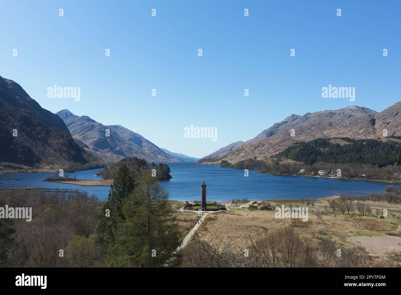 Glenfinnan Monument remembering those who died for the Jacobite cause, overlooking Loch Shiel. The monument is topped with a statue of a Highlander Stock Photo