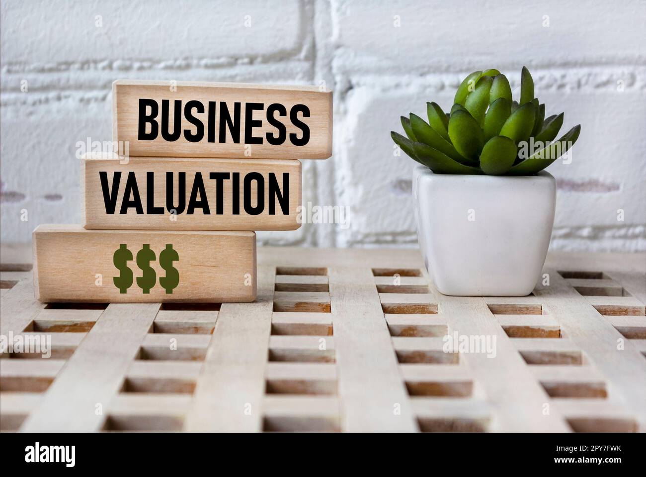Business valuation. Wooden blocks showing the words. Vintage background with a flower. Basic concepts of finance. Business theme. financial terms. Stock Photo
