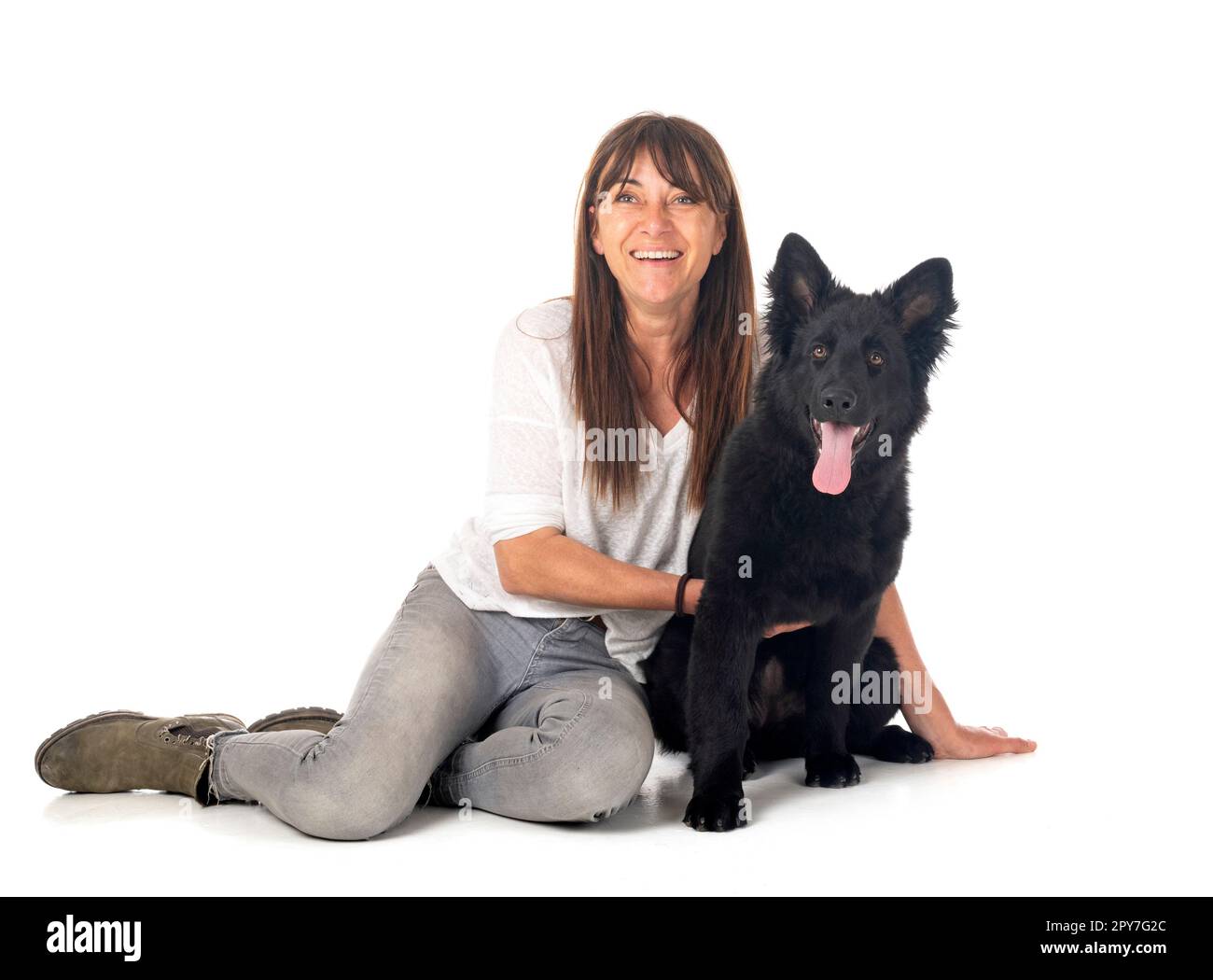 young german shepherd and woman in front of white background Stock Photo