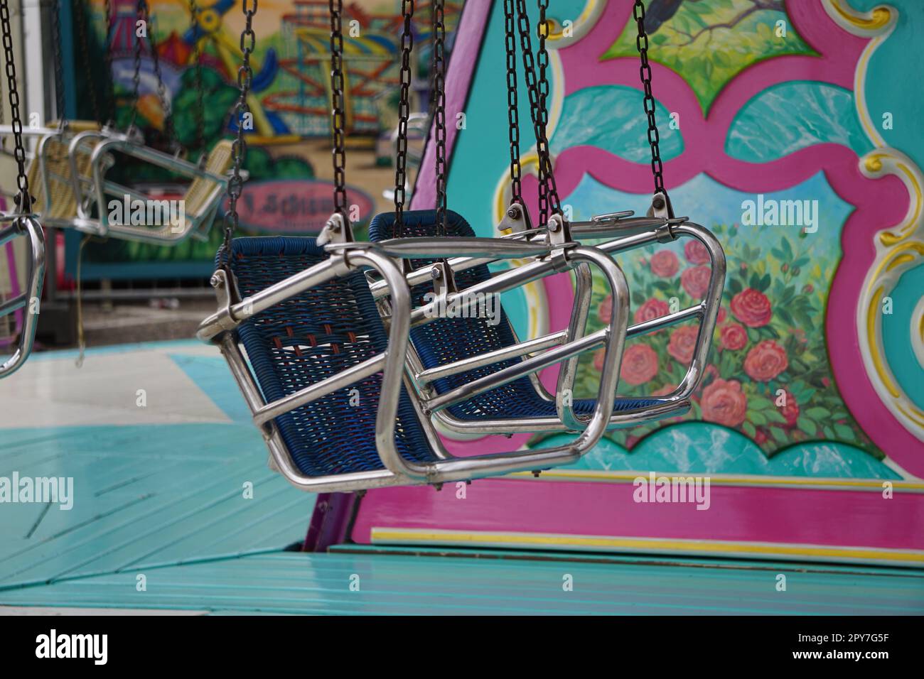 A vibrant, amusement ride at a fairground event featuring colorful swings hanging from the