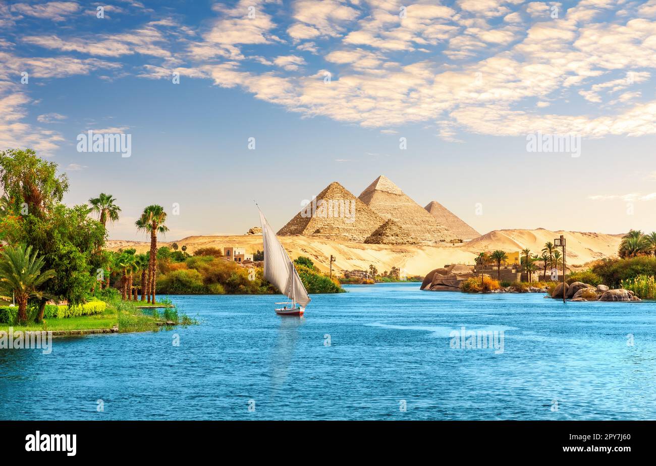 Beautiful Nile scenery  with sailboat in the Nile on the way to pyramids, Aswan, Egypt Stock Photo