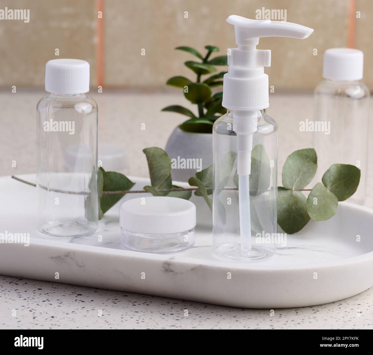 Transparent plastic container for cosmetics on the table, bottles for liquid cosmetics Stock Photo
