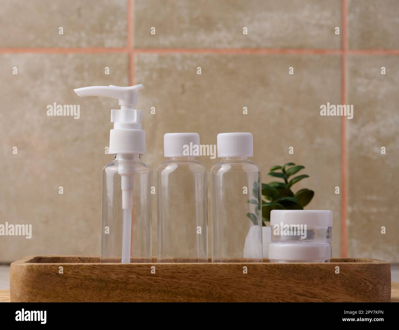 Transparent plastic container for cosmetics on the table, bottles for liquid cosmetics Stock Photo
