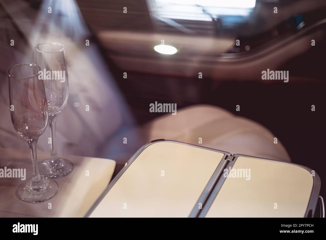 interior of a luxurious car with leather seats and two champagne