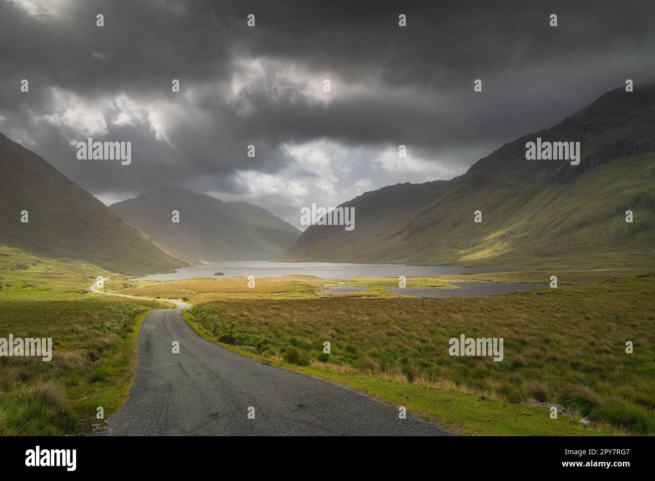 Road leading trough Doolough Valley with lakes, between mountain ranges, Ireland Stock Photo