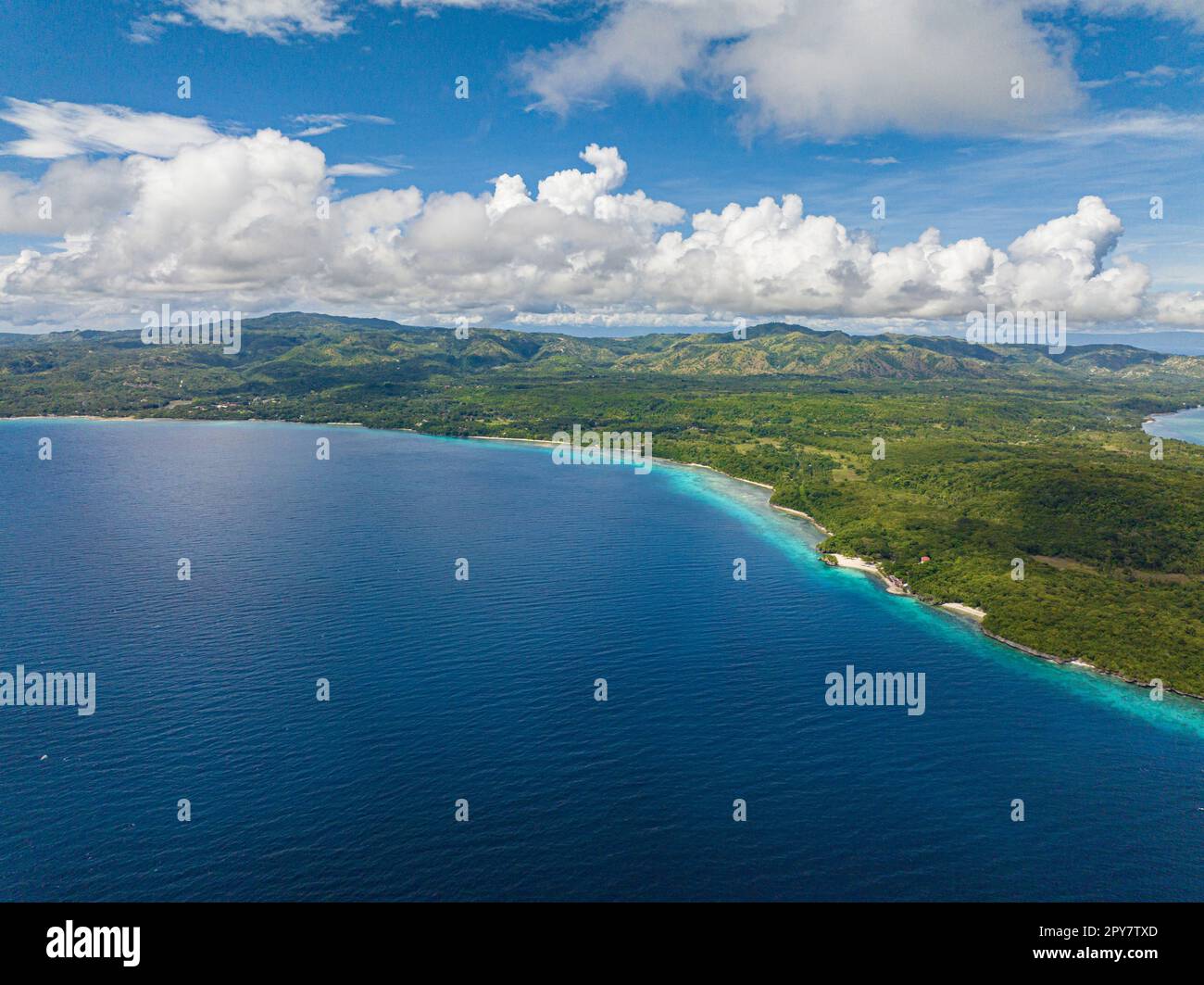 Aeerial footage of amazing mountain of Siquijor under the different clouds formation in daylight. Philippines. Stock Photo