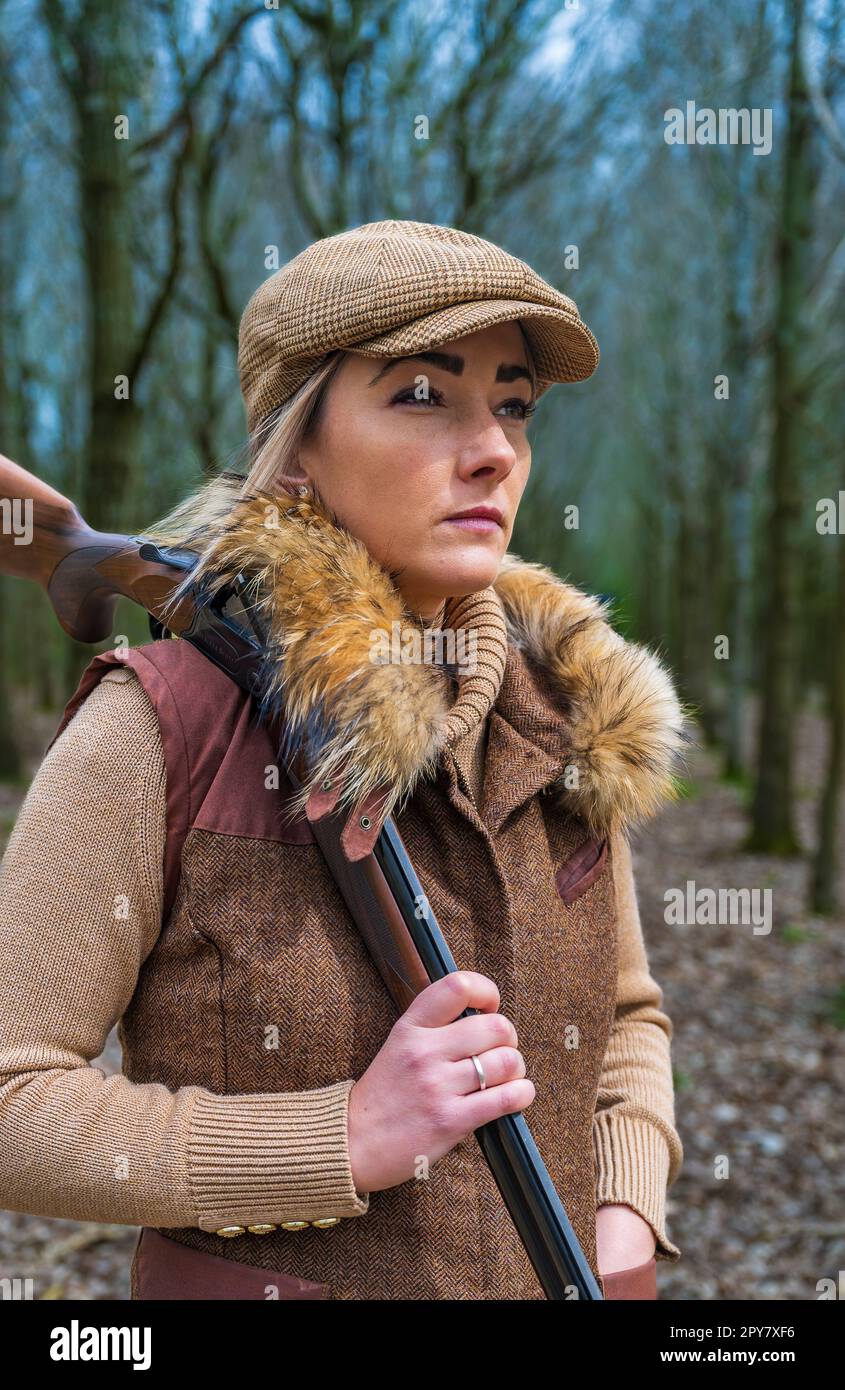 A thirty plus year old woman shooting in woodlands in the late spring