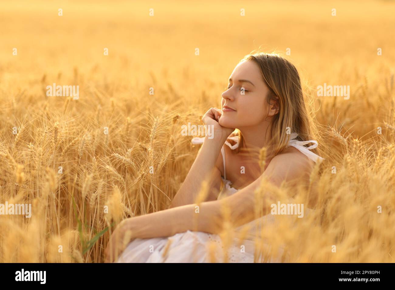 Woman relaxing alone in a field Stock Photo