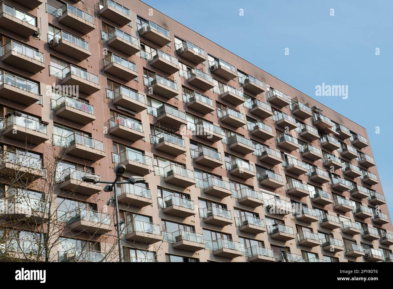Facade of large block of apartments with simple regular architecture in ...