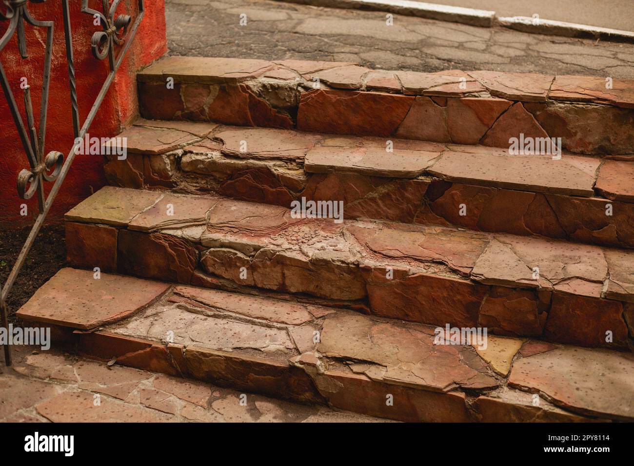 Outdoor broken tile stairs near the building. Destroyed steps. Ruins of crushed staircase Stock Photo