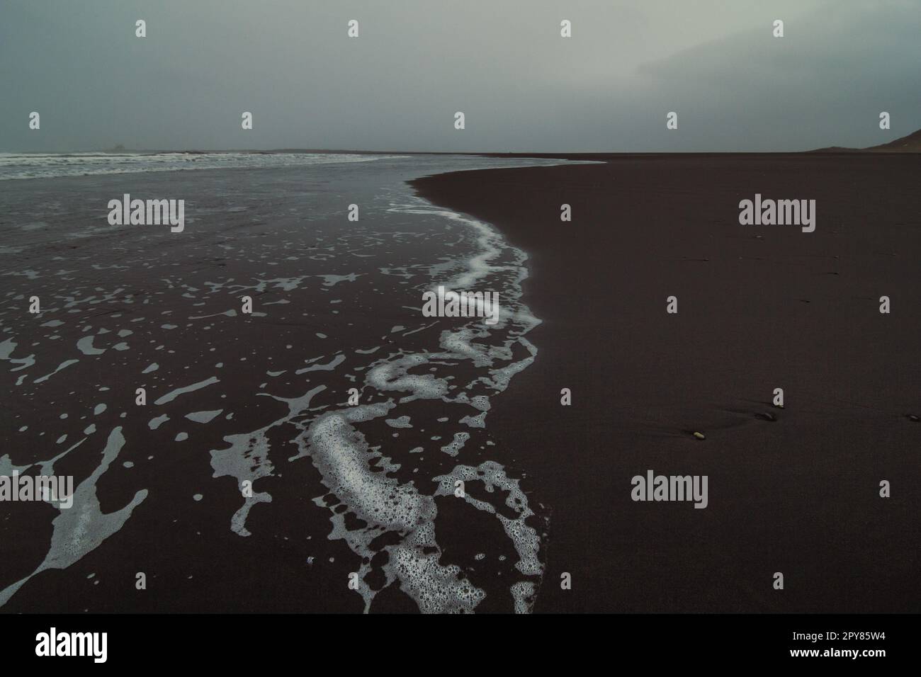 Wet surfline of black beach landscape photo Stock Photo